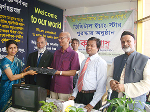 Education Minister Nurul Islam Nahid is handing over Computers to the Awardee of Digital Young Star Award as Chief Guest; Dr. M Helal is presiding over. (2010)